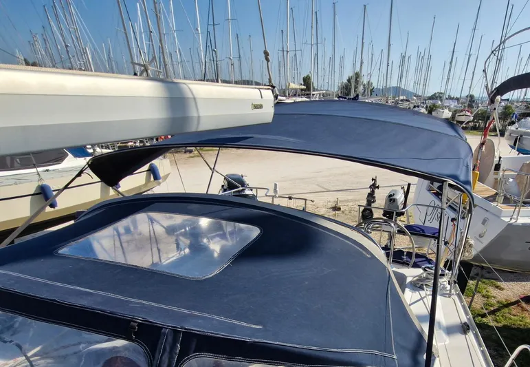  Yacht Photos Pics 2011 Catalina 445 sailboat with blue canopy, docked in a marina.