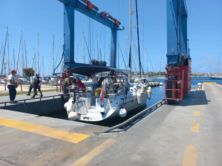  Yacht Photos Pics 2011 Catalina 445 sailboat being lifted at a marina with blue sky background.