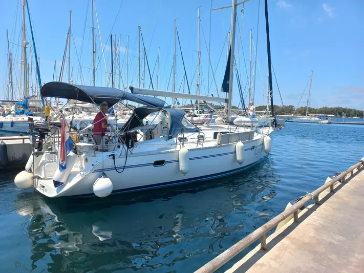  Yacht Photos Pics 2011 Catalina 445 sailboat docked in marina, clear blue sky, calm water.