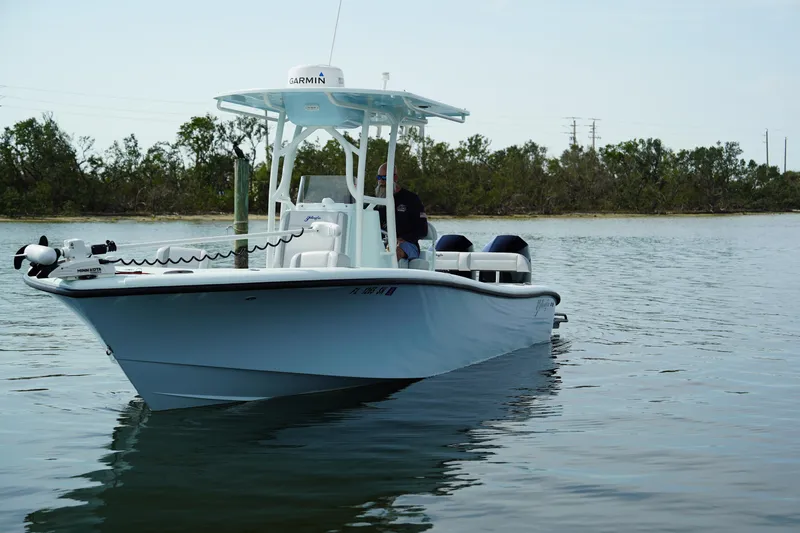  Yacht Photos Pics 2020 Yellowfin 26 Hybrid boat on calm water, featuring a sleek design and modern equipment.