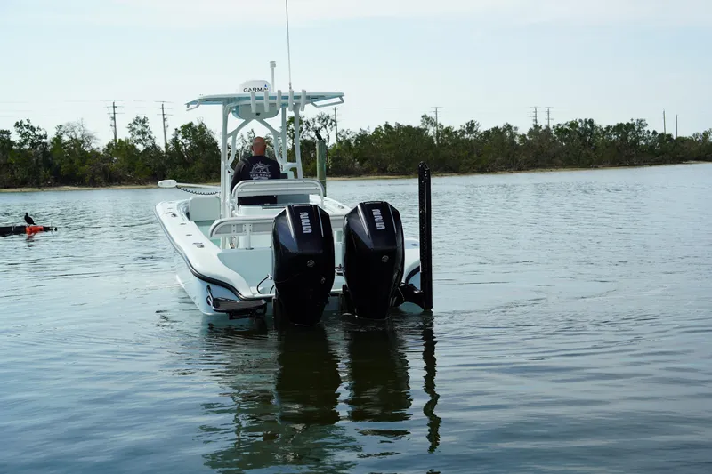  Yacht Photos Pics 2020 Yellowfin 26 Hybrid boat with dual engines on calm water.