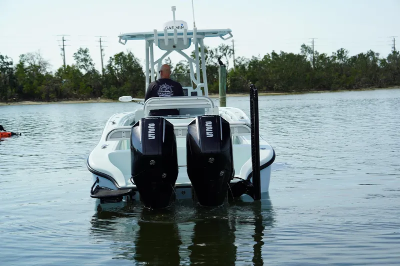  Yacht Photos Pics 2020 Yellowfin 26 Hybrid boat with dual outboard engines on calm water.