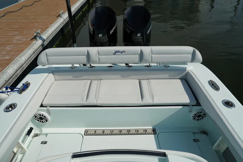  Yacht Photos Pics 2020 Yellowfin 26 Hybrid boat with cushioned seating and dual outboard motors at a dock.