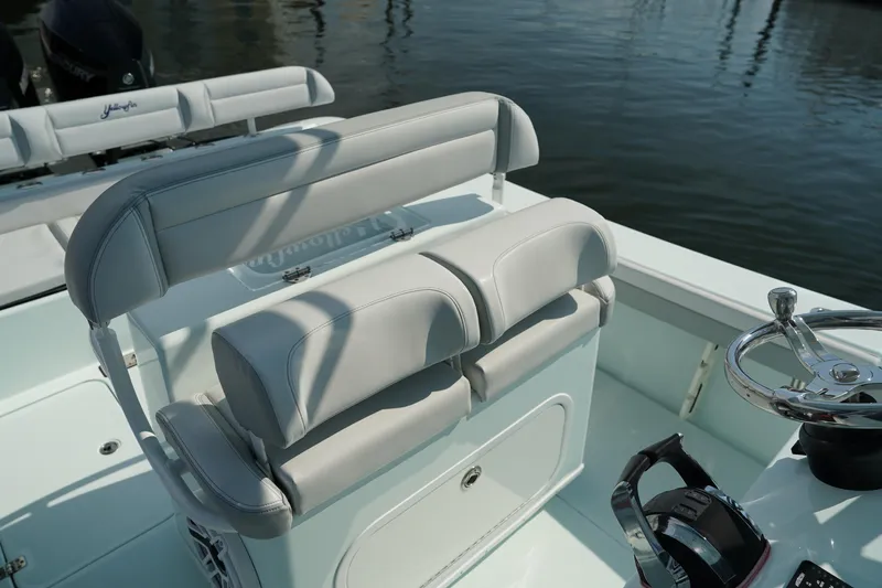  Yacht Photos Pics 2020 Yellowfin 26 Hybrid boat interior with cushioned seating and steering wheel.