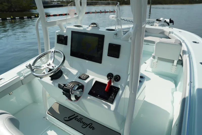  Yacht Photos Pics 2020 Yellowfin 26 Hybrid boat console with steering wheel and navigation system.
