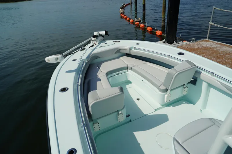  Yacht Photos Pics 2020 Yellowfin 26 Hybrid boat with spacious seating, docked by the water.