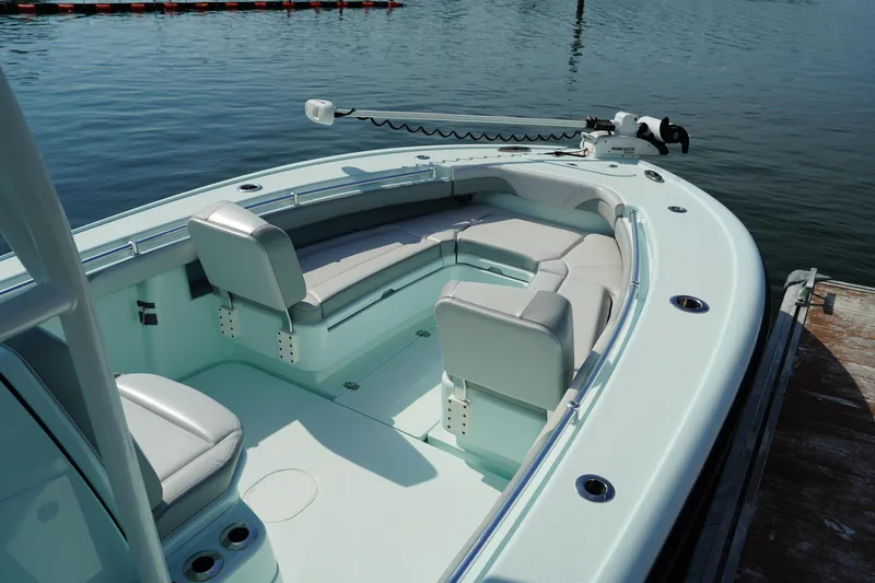  Yacht Photos Pics 2020 Yellowfin 26 Hybrid boat with seating, docked on calm water.
