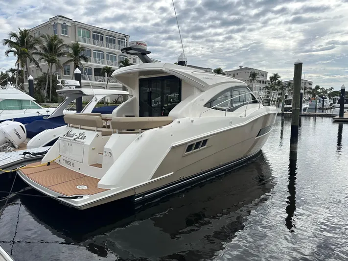 Nauti-lin Yacht Photos Pics 2016 Carver C37 Coupe yacht docked at marina, cloudy sky background.
