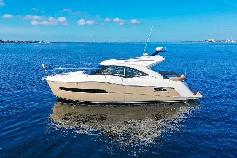 Nauti-lin Yacht Photos Pics 2016 Carver C37 Coupe yacht on calm blue water under clear sky.