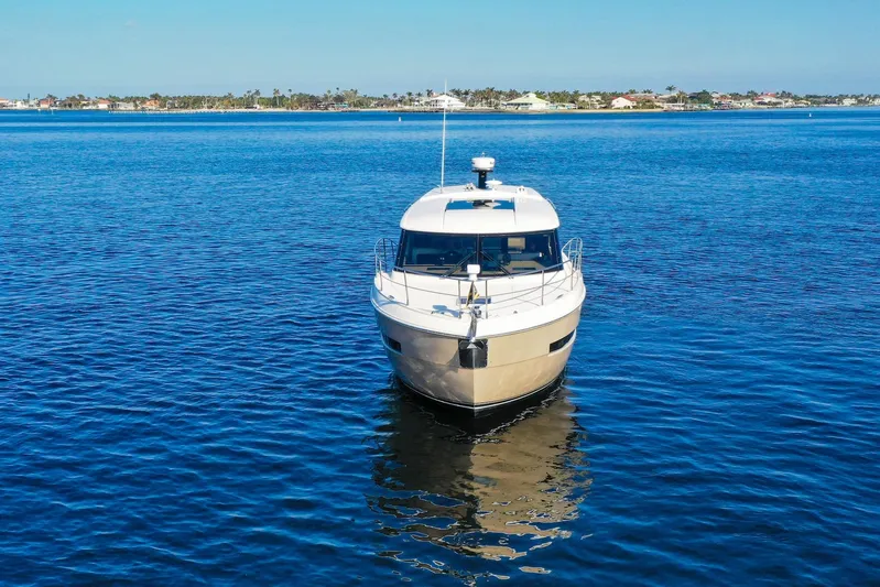 Nauti-lin Yacht Photos Pics 2016 Carver C37 Coupe yacht on calm blue water, front view.
