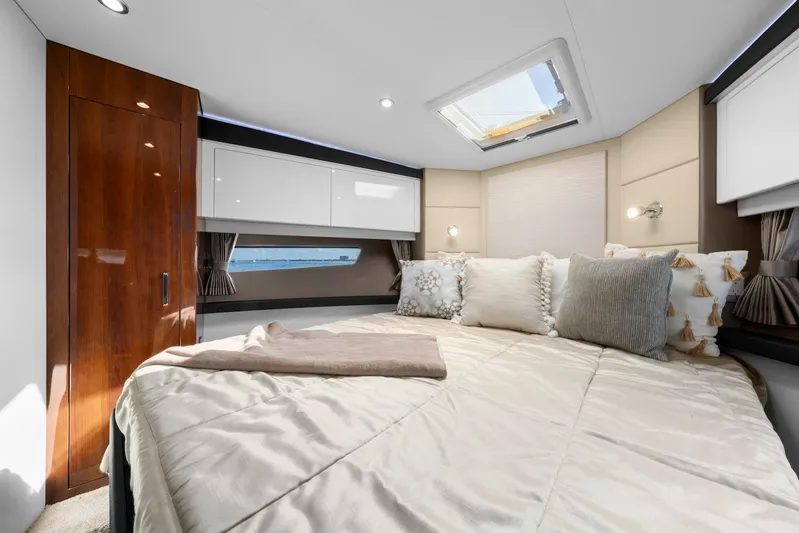 Nauti-lin Yacht Photos Pics Luxurious bedroom interior of 2016 Carver C37 Coupe yacht with skylight and elegant decor.