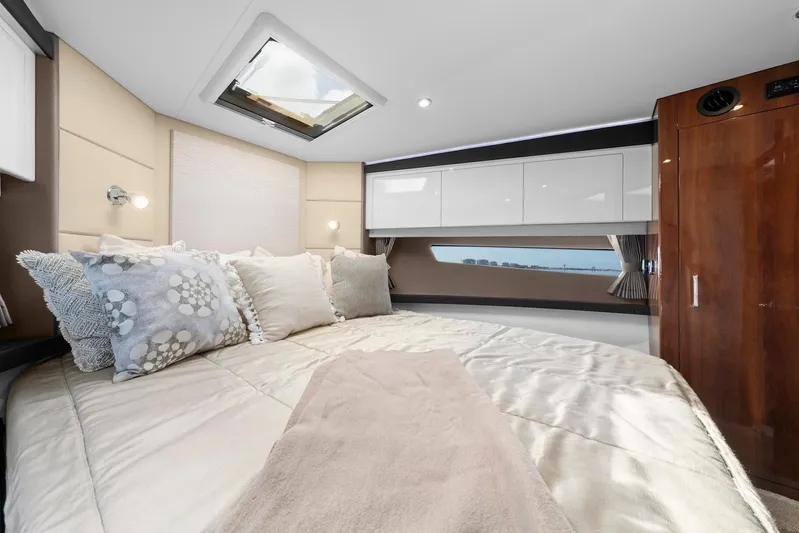 Nauti-lin Yacht Photos Pics Luxurious bedroom interior of 2016 Carver C37 Coupe yacht with skylight and elegant bedding.