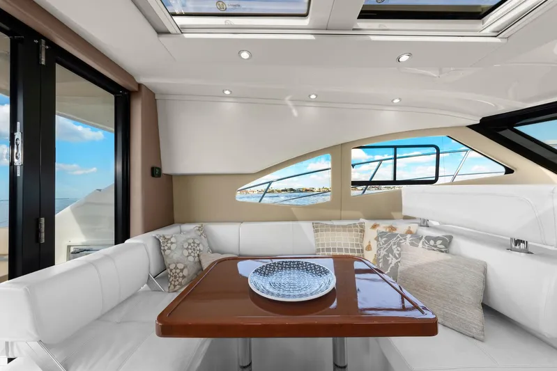Nauti-lin Yacht Photos Pics Interior of 2016 Carver C37 Coupe yacht with elegant seating and table.