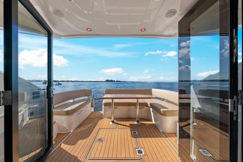 Nauti-lin Yacht Photos Pics 2016 Carver C37 Coupe yacht interior with ocean view, featuring elegant seating and wooden flooring.