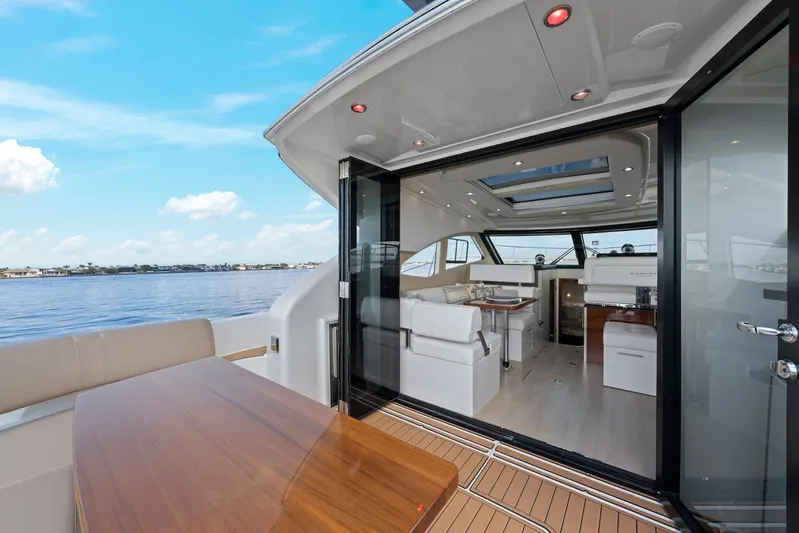 Nauti-lin Yacht Photos Pics 2016 Carver C37 Coupe yacht interior with open deck, wooden table, and scenic water view.
