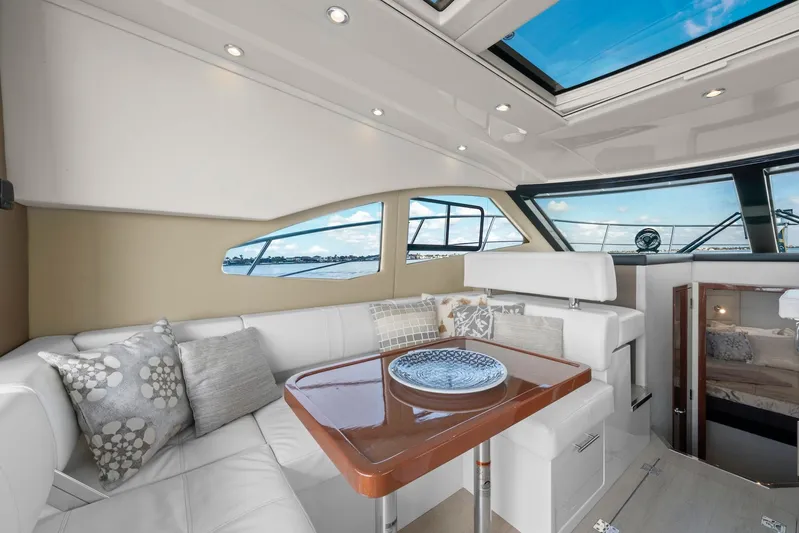 Nauti-lin Yacht Photos Pics Luxurious interior of 2016 Carver C37 Coupe yacht with elegant seating and panoramic windows.