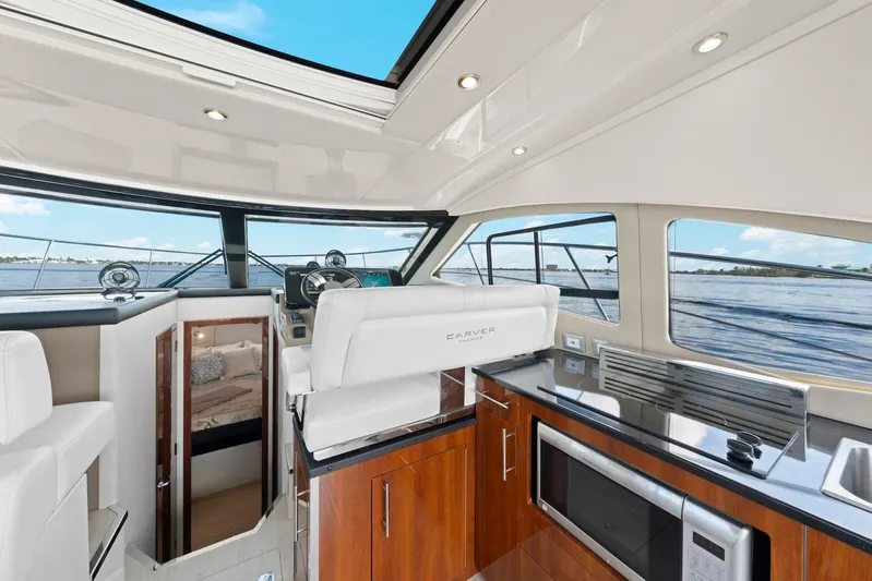 Nauti-lin Yacht Photos Pics Interior of 2016 Carver C37 Coupe yacht with modern kitchen and helm.