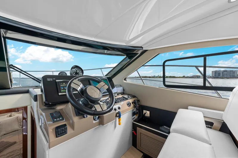 Nauti-lin Yacht Photos Pics Interior of 2016 Carver C37 Coupe yacht, featuring modern helm and navigation equipment.