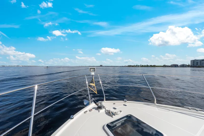 Nauti-lin Yacht Photos Pics Bow view from 2016 Carver C37 Coupe on open water under blue sky.