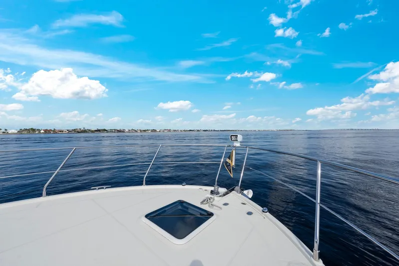 Nauti-lin Yacht Photos Pics 2016 Carver C37 Coupe yacht cruising on open water under a clear blue sky.