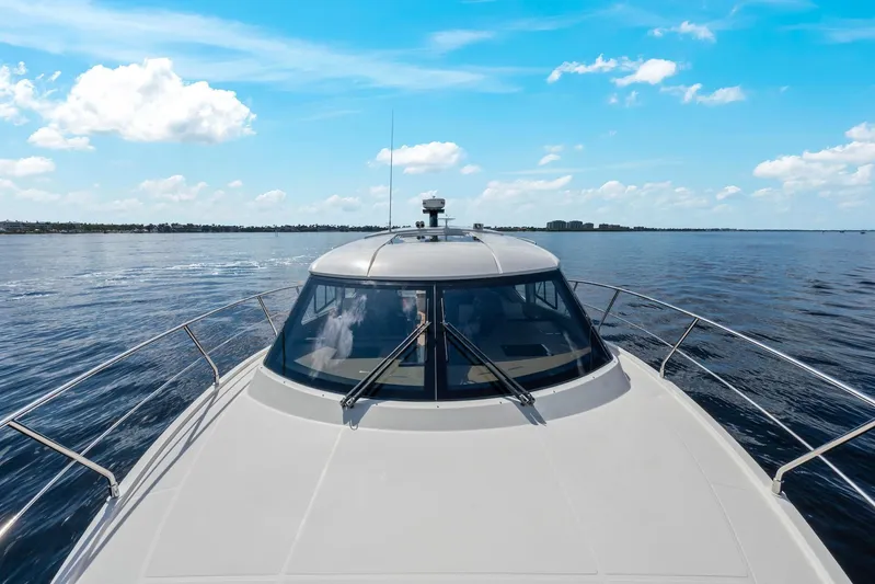 Nauti-lin Yacht Photos Pics 2016 Carver C37 Coupe yacht cruising on open water under a clear blue sky.