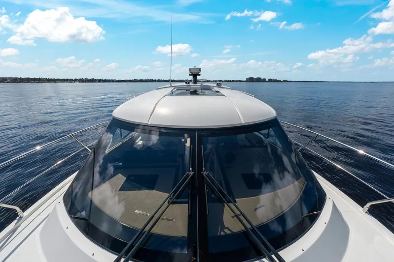 Nauti-lin Yacht Photos Pics 2016 Carver C37 Coupe yacht cruising on open water under a clear blue sky.