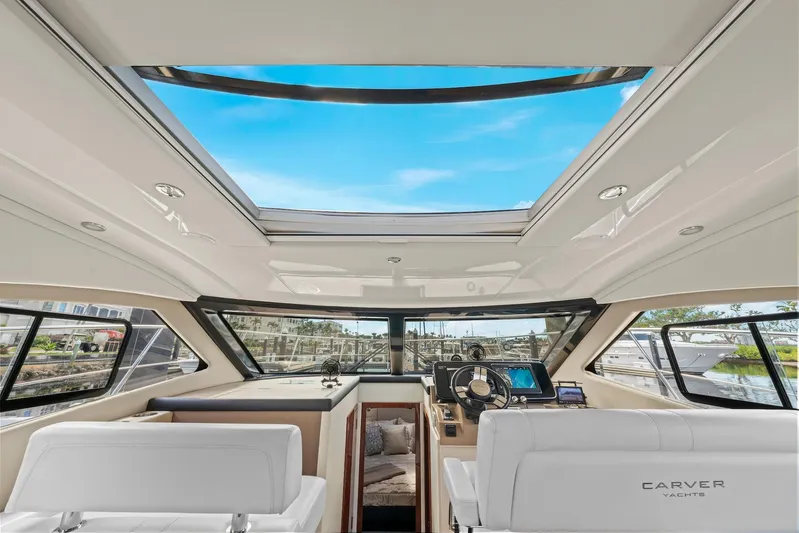 Nauti-lin Yacht Photos Pics Interior of 2016 Carver C37 Coupe yacht with panoramic sunroof and modern helm.