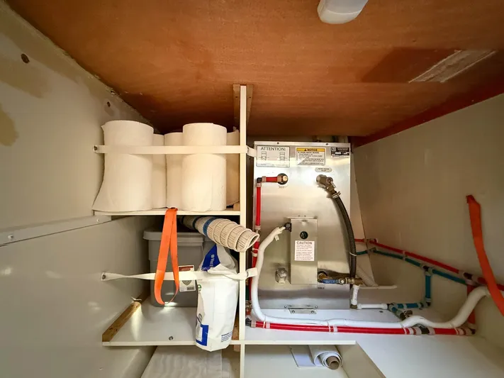 Nauti-lin Yacht Photos Pics Storage compartment in a 2016 Carver C37 Coupe with plumbing and supplies.