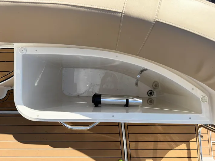Nauti-lin Yacht Photos Pics Storage compartment on a 2016 Carver C37 Coupe boat with wooden deck.