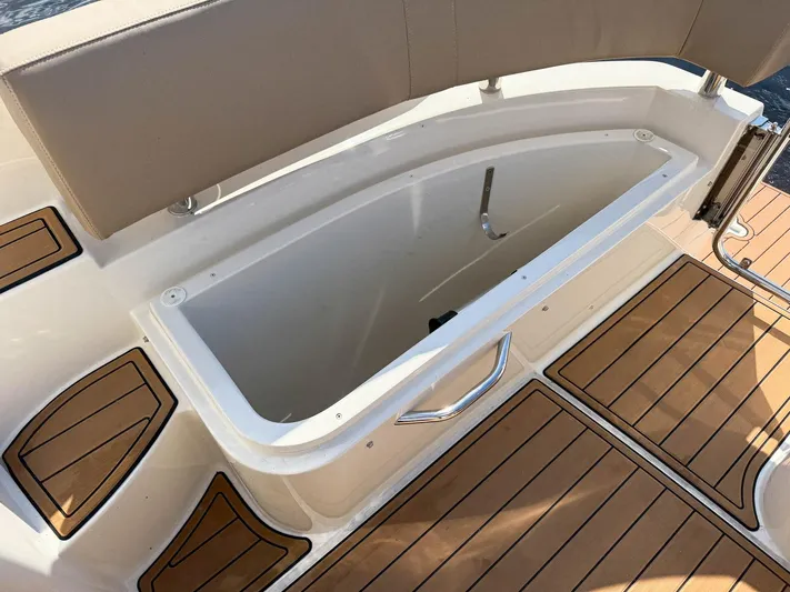 Nauti-lin Yacht Photos Pics 2016 Carver C37 Coupe boat storage compartment with teak flooring.