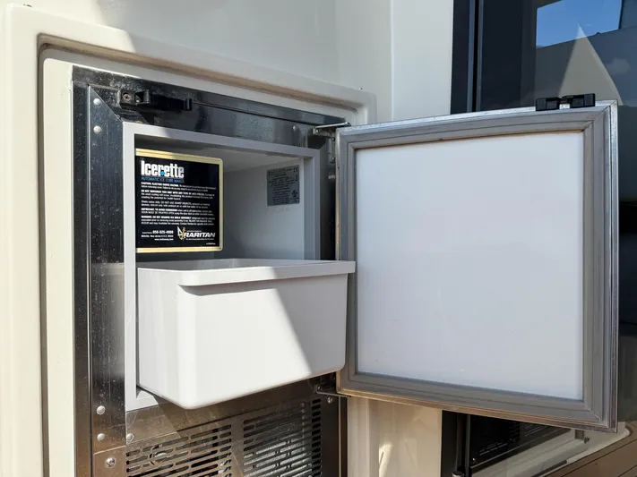 Nauti-lin Yacht Photos Pics Ice maker in 2016 Carver C37 Coupe yacht, open with visible ice tray.