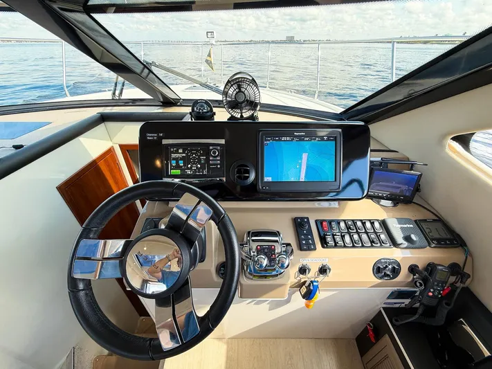 Nauti-lin Yacht Photos Pics Helm of 2016 Carver C37 Coupe yacht with modern navigation equipment.