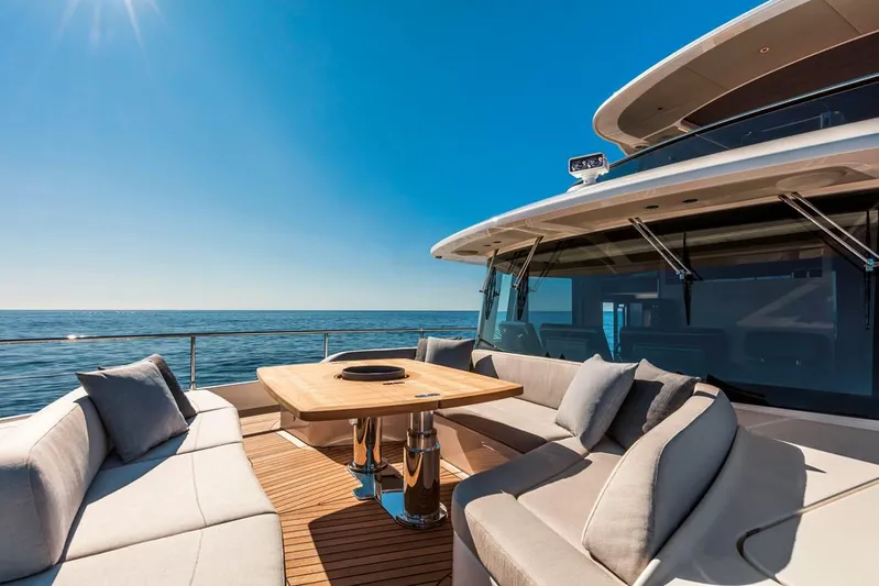  Yacht Photos Pics Luxurious 2019 Absolute Navetta 73 yacht with elegant outdoor seating and ocean view.