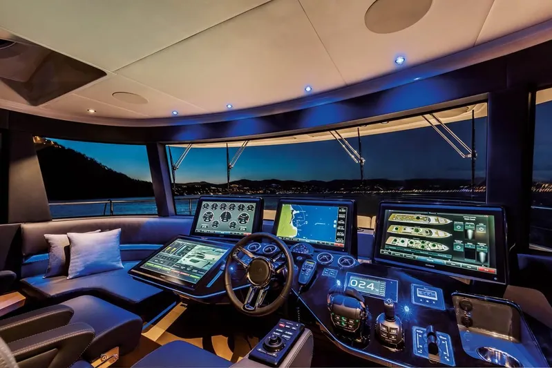  Yacht Photos Pics Luxurious 2019 Absolute Navetta 73 yacht cockpit with advanced navigation systems at night.