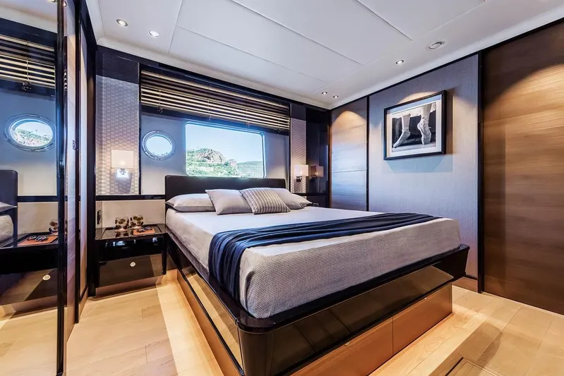  Yacht Photos Pics Luxurious bedroom interior on 2019 Absolute Navetta 73 yacht, featuring elegant decor and large window.