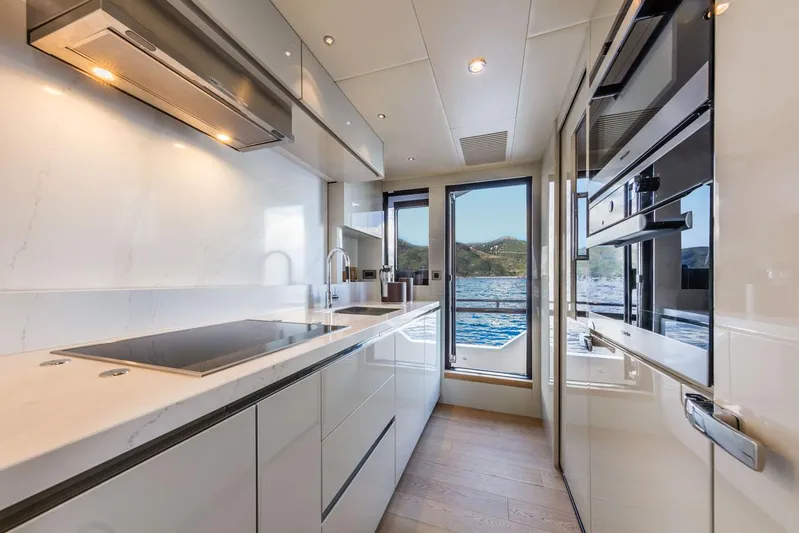  Yacht Photos Pics Luxurious kitchen interior of 2019 Absolute Navetta 73 yacht with ocean view.