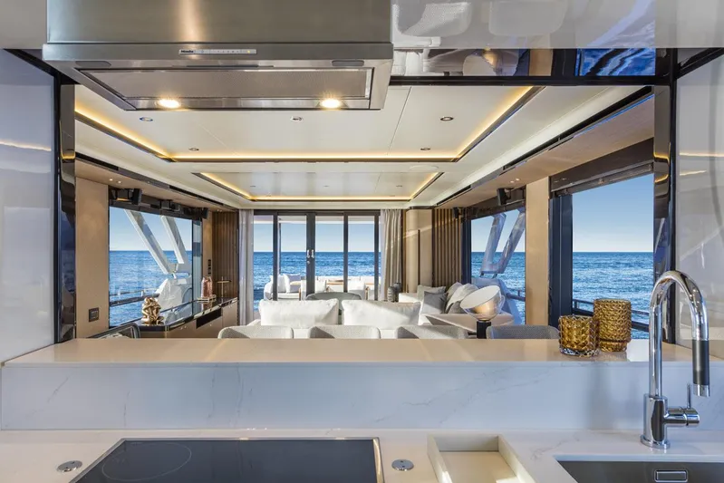 Yacht Photos Pics Luxurious interior of 2019 Absolute Navetta 73 yacht with ocean view through large windows.