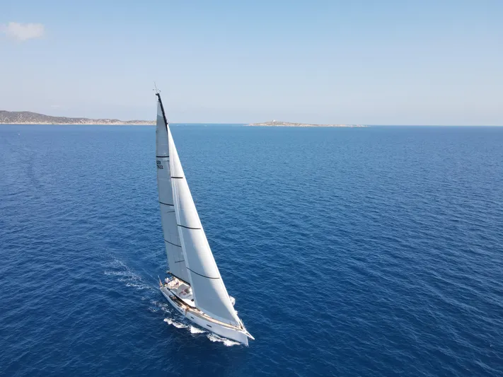 Juul Yacht Photos Pics Sailing yacht CNB 66 (2019) gliding on open sea under clear blue sky.