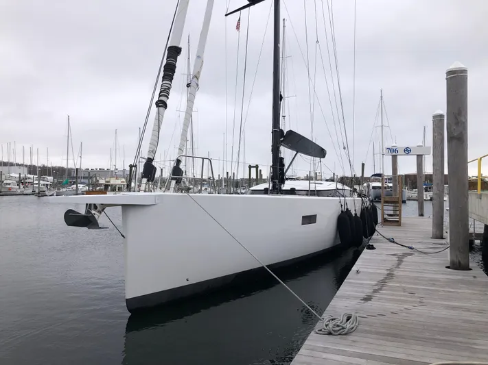 Juul Yacht Photos Pics Sleek 2019 CNB 66 yacht docked at marina on a cloudy day.