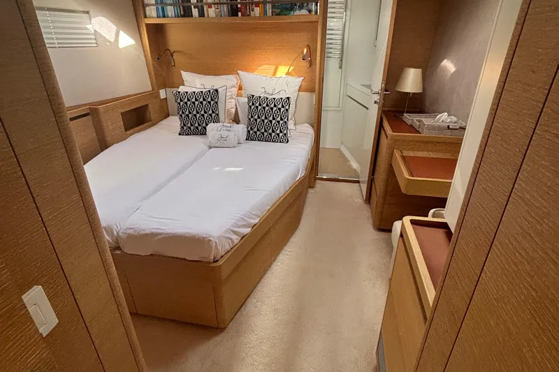 Juul Yacht Photos Pics Luxurious cabin interior of 2019 CNB 66 yacht with cozy bed and elegant decor.