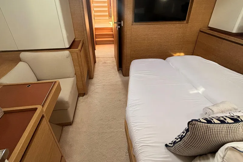 Juul Yacht Photos Pics Luxurious cabin interior of 2019 CNB 66 yacht with bed, seating, and TV.