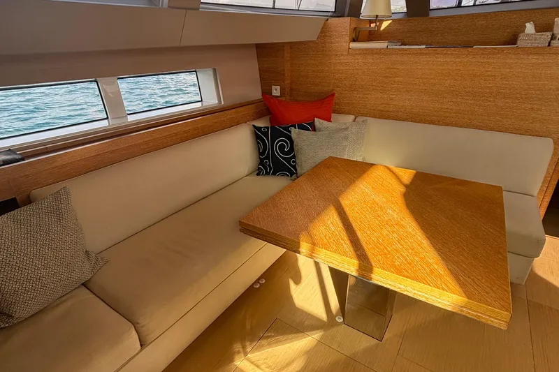 Juul Yacht Photos Pics Luxurious CNB 66 yacht interior with cozy seating and wooden table, 2019 model.