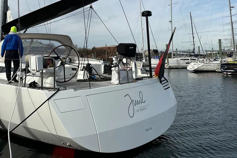 Juul Yacht Photos Pics Sailing yacht CNB 66, 2019 model, docked in a marina with a person on deck.