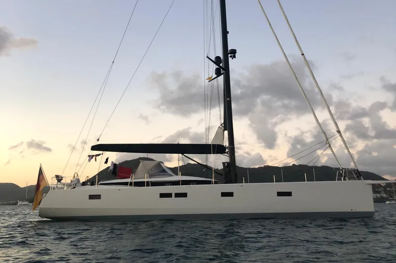 Juul Yacht Photos Pics 2019 CNB 66 yacht at sunset, anchored in calm waters.