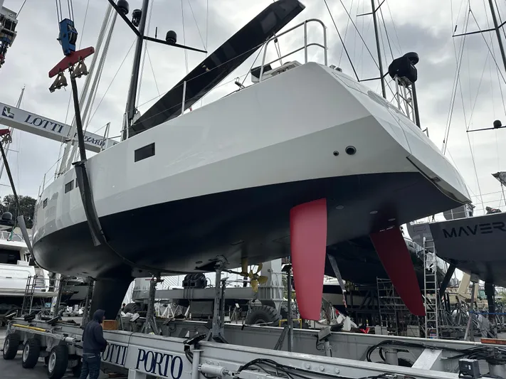 Juul Yacht Photos Pics 2019 CNB 66 yacht on a trailer in a shipyard, showcasing its sleek design and red keel.
