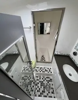 Insta Gator Yacht Photos Pics Bathroom interior of 2017 Royal Cape Catamarans Majestic 53 with modern fixtures and checkered flooring.