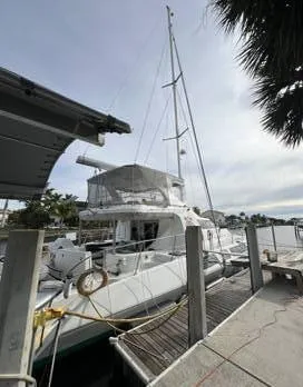 Insta Gator Yacht Photos Pics 2017 Royal Cape Catamarans Majestic 53 docked at a marina, side view.