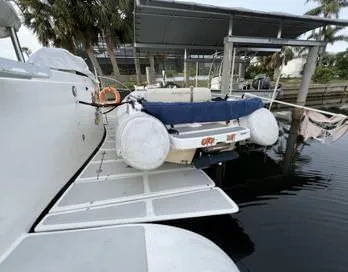 Insta Gator Yacht Photos Pics 2017 Royal Cape Catamarans Majestic 53 docked with inflatable boat and covered seating.