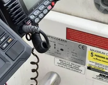 Insta Gator Yacht Photos Pics Control panel of a 2017 Royal Cape Catamarans Majestic 53 with safety labels and radio equipment.