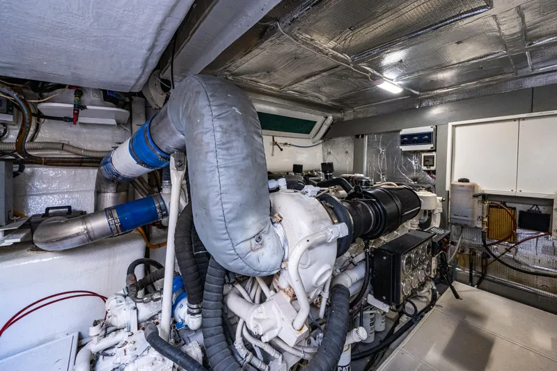  Yacht Photos Pics Engine room of a 2000 Pershing 65 Limited yacht, showcasing mechanical components.